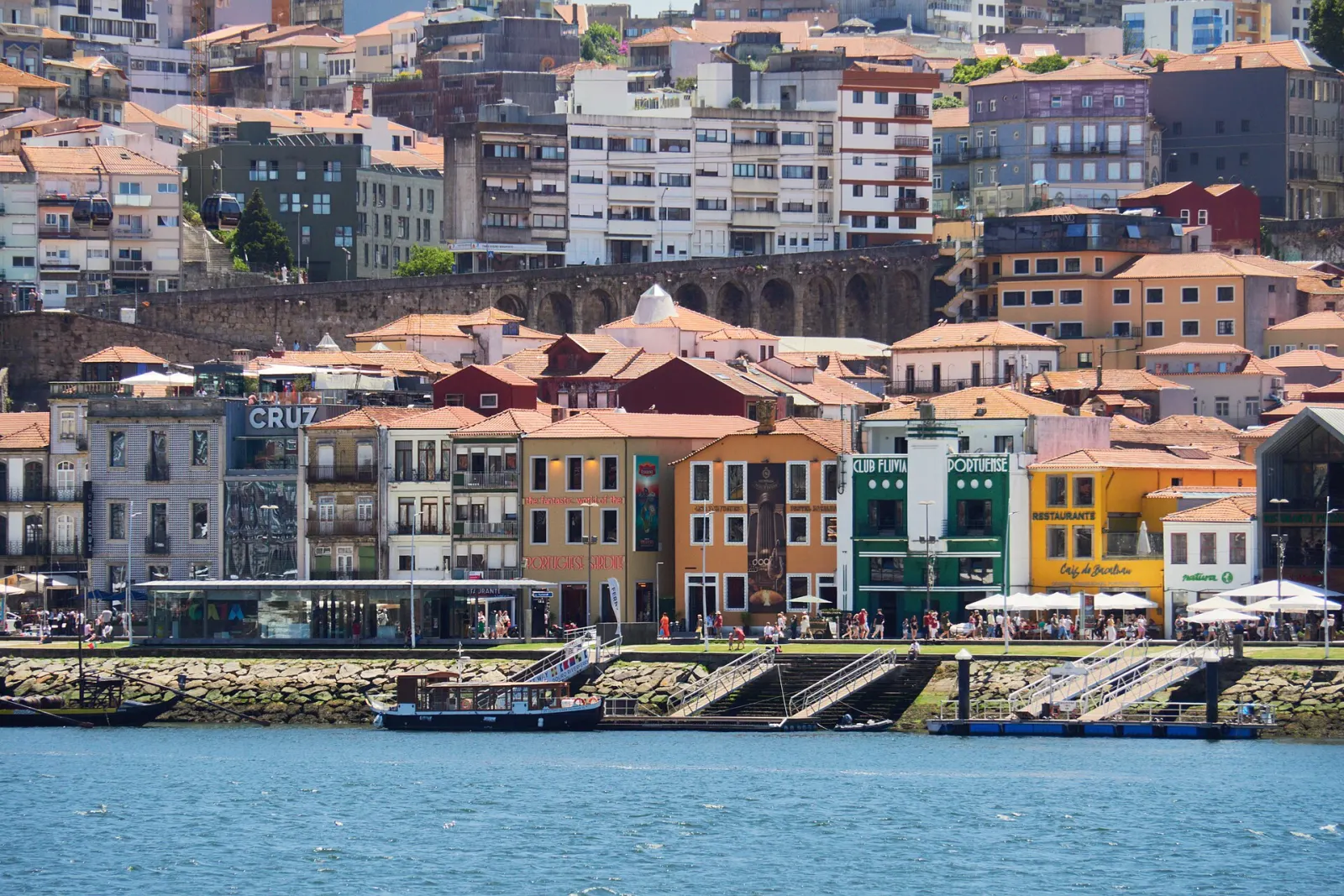 Port wine lodges along the Vila Nova de Gaia waterfront, seen across the Douro